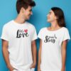 couple-wearing-white-t-shirt-in-front-of-plain-blue-screen-0205 (5) "Let's Love - Write a Story" Couples T-Shirts