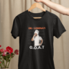 mockup-of-a-woman-s-hand-holding-a-hanger-with-a-t-shirt-over-a-table-with-flowers-m23501 (8) Dil-Luminati G.O.A.T Unisex T-Shirt