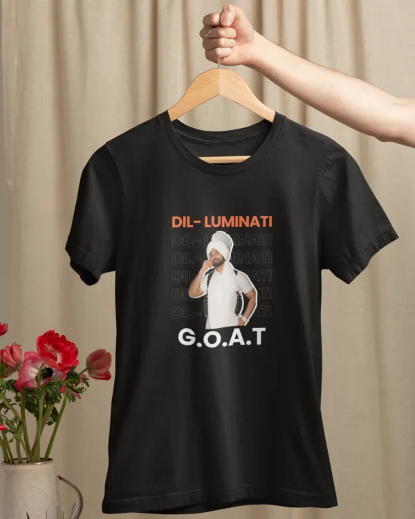 mockup-of-a-woman-s-hand-holding-a-hanger-with-a-t-shirt-over-a-table-with-flowers-m23501 (8) Dil-Luminati G.O.A.T Unisex T-Shirt