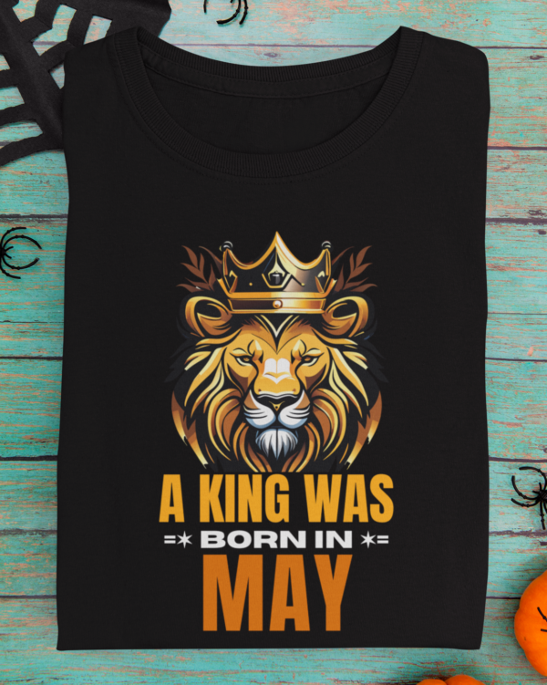 mockup-of-a-folded-t-shirt-featuring-halloween-decorations-m101 (3) A King Was Born in May Unisex T-Shirt