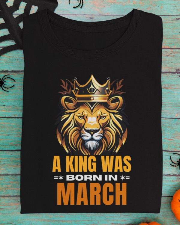 mockup-of-a-folded-t-shirt-featuring-halloween-decorations-m101 (4) A King Was Born in March Unisex T-Shirt